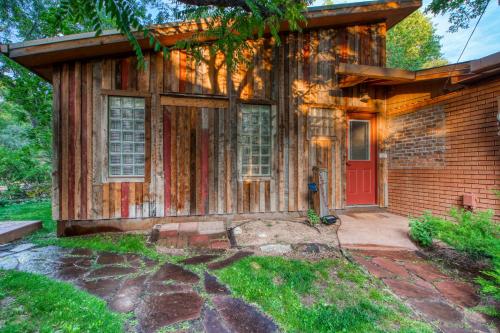 a home with a red door and a brick at Creekside Cowa-Bungalow! in Moab