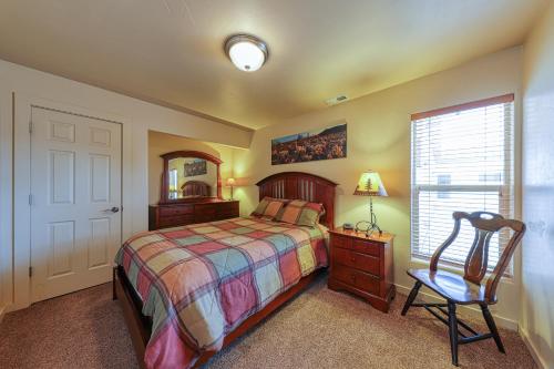 a bedroom with a bed and a chair and a mirror at Rim Village O3 in Moab