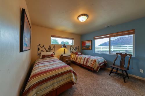 a bedroom with two beds and a window at Rim Village O3 in Moab