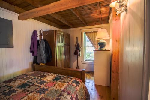 a bedroom with a bed and a lamp in a room at Harpswell Bay House in East Harpswell