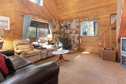 a living room with a couch and a fireplace at Sabala Cabin in Randolph