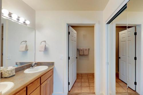 a bathroom with two sinks and a mirror at Rim Vista 5A5 in Moab