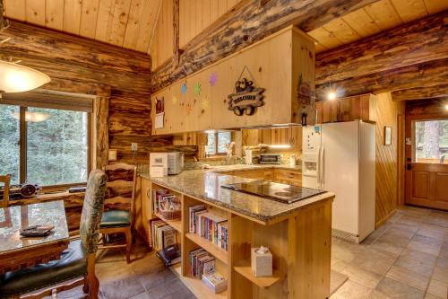 a kitchen with a counter and a refrigerator at Bear Hollow Cabin in Tacoma