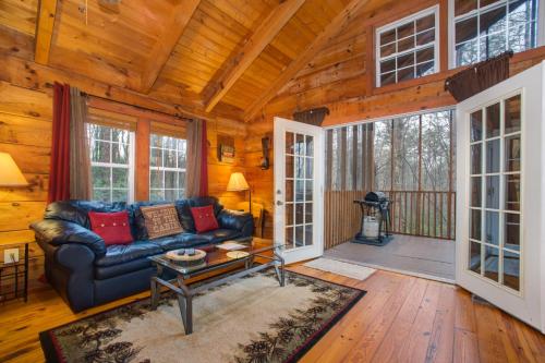 a living room with a couch and a table at Shasta in Sautee Nacoochee