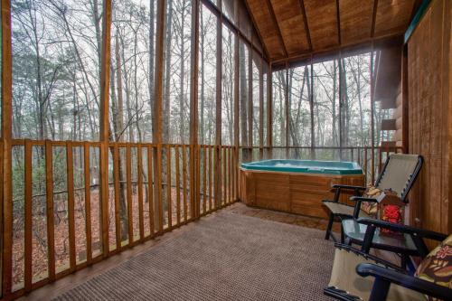 a screened in porch with a tub in the woods at Shasta in Sautee Nacoochee