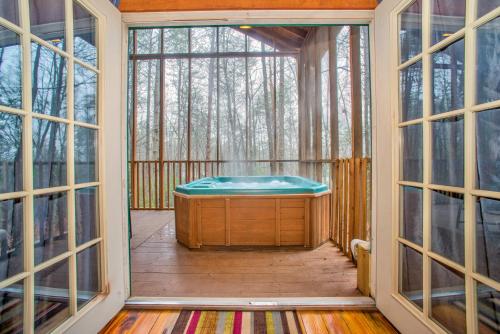 a jacuzzi tub on a screened in porch with windows at Shasta in Sautee Nacoochee