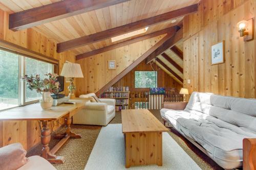 a living room with a couch and a table at The Chalet on Lopez in Islandale