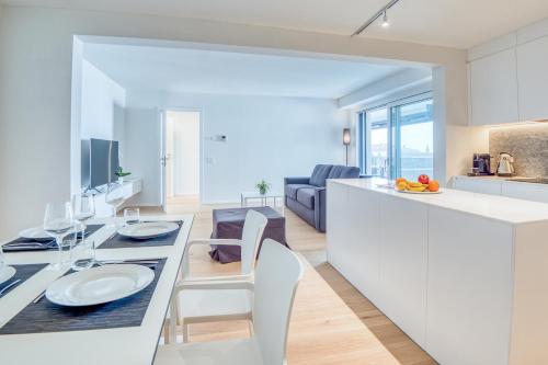 a kitchen and living room with a table and chairs at Sasso Boretto, Luxury Holiday Apartments in Ascona