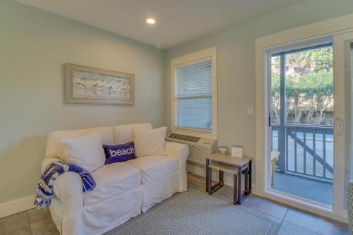 a living room with a white couch and a window at 104 Inlet Sands Condo in Inlet Beach