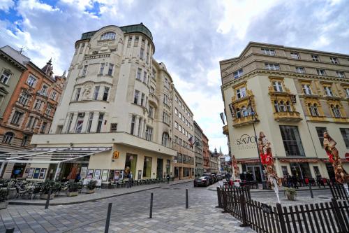 a street with two tall buildings on a city street at Apartmánový Dům Centrum in Brno