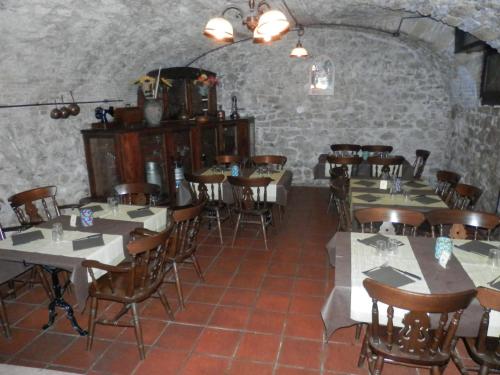 a dining room with tables and chairs in a building at Locanda del Vecchio Maglio in Terni