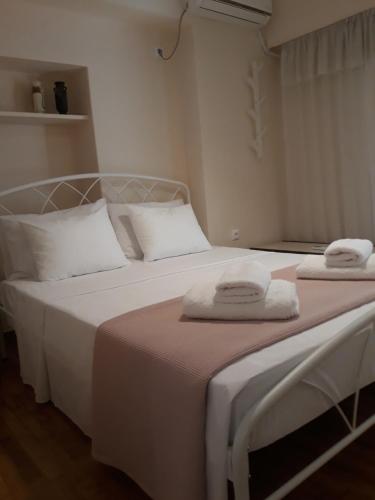 a bedroom with two beds with towels on them at Koukaki apartment near Acropolis in Athens