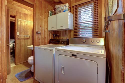 a small kitchen with a stove and a washer at Pee Wee Acres in Thayerville