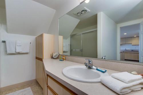 uma casa de banho com um lavatório e um espelho em Whaler's Getaway em Depoe Bay