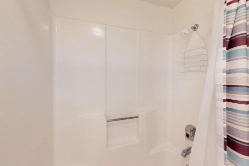 a bathroom with a shower with a shower curtain at Ventura in South Padre Island