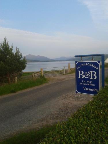 a sign on the side of a road at Mo-Dhachaidh B&B in Poolewe