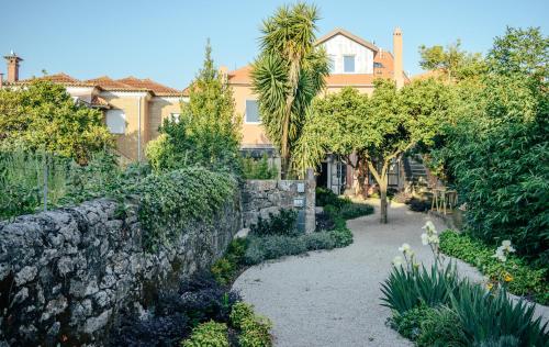 a stone wall in front of a house at Queen's Garden Hostel in Porto