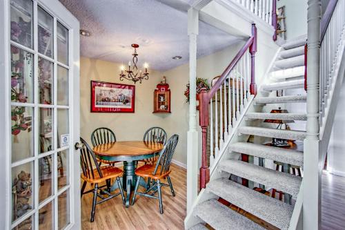 a dining room with a table and chairs and a staircase at Bearadise in Ellijay