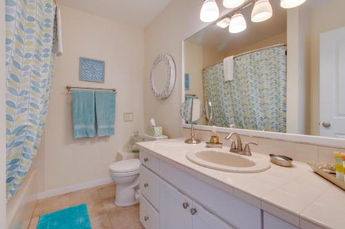 a bathroom with a sink and a toilet and a mirror at Surfside Suite On The Sea, Too in Gearhart
