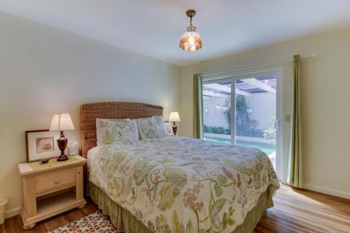 a bedroom with a bed and a large window at Vintage Views in Cayucos