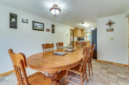 a kitchen and dining room with a wooden table and chairs at Still Meadows in McComas Beach