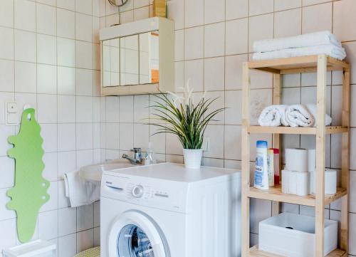 a bathroom with a washing machine and a sink at Ferienhaus Mountain View in Spital am Pyhrn
