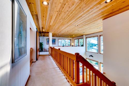 a hallway with a wooden ceiling with windows at Cliffside Serenity in Oceanside