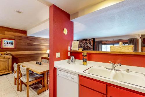 a kitchen with a sink and a dining table at Snowcreek 1538 in Sun Valley