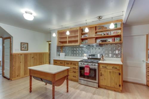 a kitchen with wooden cabinets and a stove at Renee's Log House in McKenzie Bridge