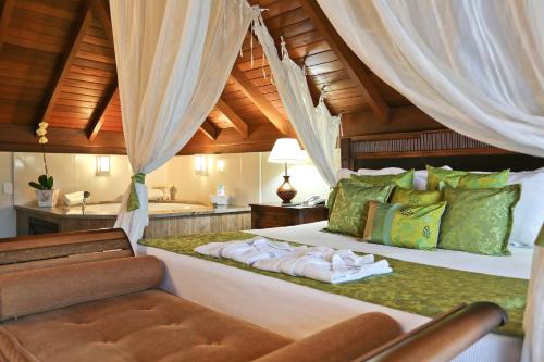 a bedroom with a large bed and a sink at Estaleiro Guest House in Balneário Camboriú