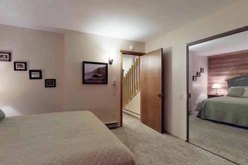 a bedroom with a bed and a door leading to a hallway at Blue Jay Condominium in Lakeshore