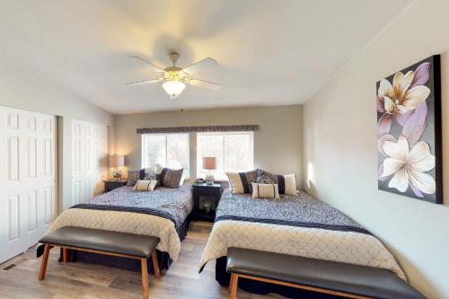 a bedroom with two beds and a ceiling fan at Manson Lake House in Manson