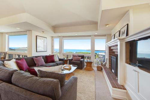 a living room with a couch and a television at Harbour House in Bodega Bay