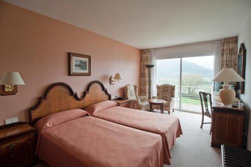 Llit o llits en una habitació de Hotel Riu Fluviá