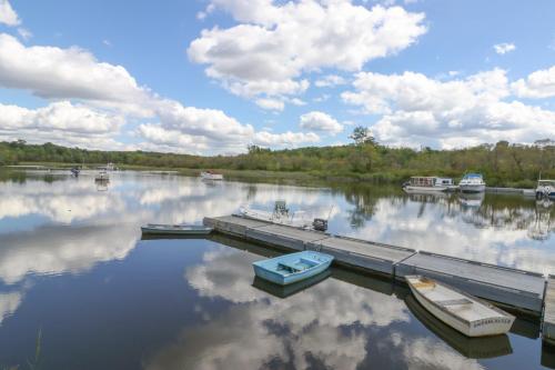 two boats are docked at a dock on a lake at Eagles View in Bowdoinham