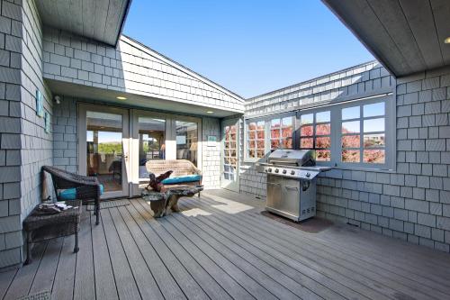 a screened porch with a grill on a house at Harbour House in Bodega Bay