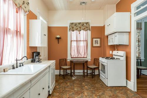 a kitchen with a sink and a stove at Victorian Galveston House in Galveston