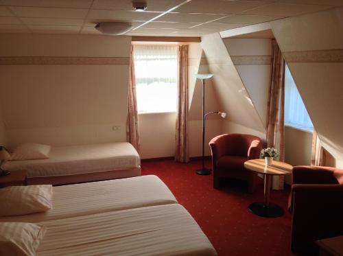 En eller flere senge i et værelse på SuyderSee Hotel
