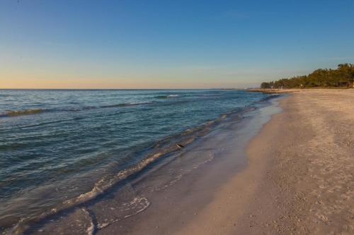 a view of a sandy beach with the ocean at Safari Suite in Bradenton Beach