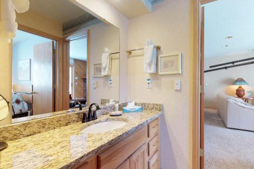 a bathroom with a sink and a large mirror at Snowdance Condominiums B102 in Keystone