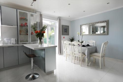 a kitchen and dining room with a table and chairs at Amazing London in London