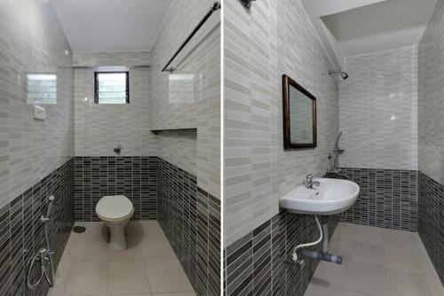 a bathroom with a sink and a toilet at Roundcube Guest House in Palolem