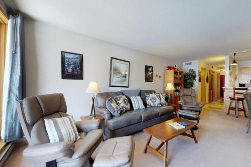 a living room with a couch and a table at Ski Run Condominiums 203 in Keystone