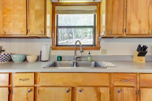 a kitchen with a sink and a window at Moss Creek Cabin in Morganton
