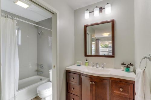 a bathroom with a sink and a toilet and a mirror at Mercer Island- Mt Saint Helens Room in Mercer Island