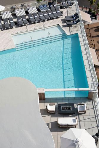 an overhead view of a swimming pool with chaises and chairs at Wave Resort in Long Branch