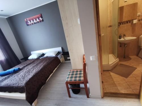 a bedroom with a bed and a bathroom with a shower at Hotel Privat in Tallinn