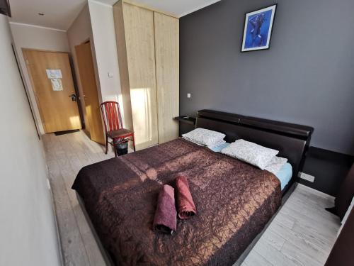 a bedroom with a large bed with two pillows on it at Hotel Privat in Tallinn