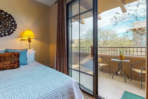 a bedroom with a bed and a balcony at Village at Carefree in Carefree