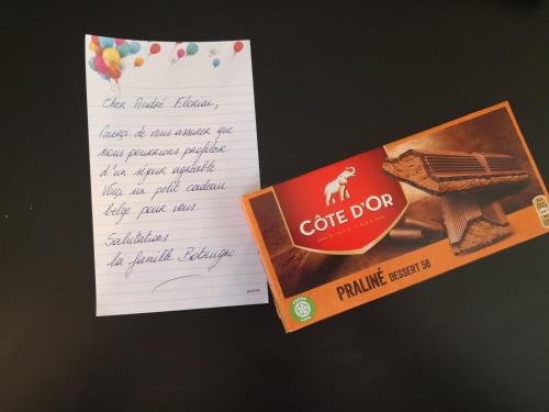 a piece of paper next to a box of coffee box at Groom Epernay - Jacuzzi & Champagne in Épernay